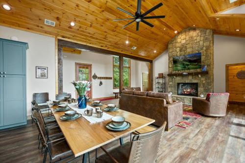 a dining room with a table and a fireplace at Fantastic Cabin with Pool Table and Games in Gartlinburg, Tennessee in Chalet Village