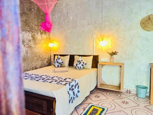 a bedroom with a bed and a table with a mirror at Nethu Freedom Cottage in Weligama