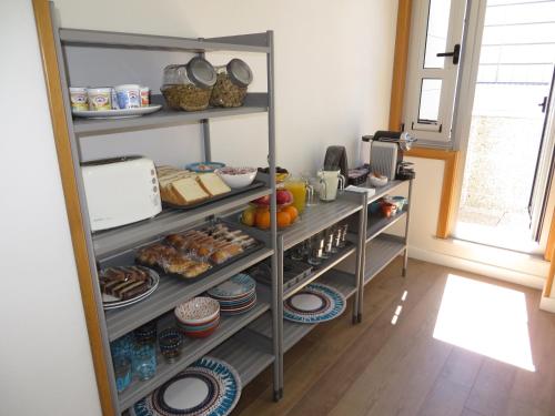 a pantry with shelves filled with food and other items at Toctoc Rooms in A Coruña