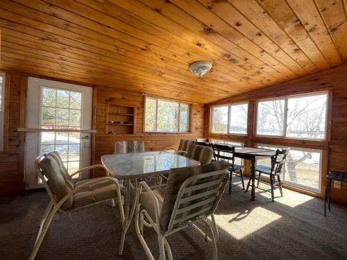 a dining room with a table and chairs in a cabin at Embrace Nature in this Breathtaking Cottage in Portage Lake, Maine in Portage Lake Municipal Seaplane Base