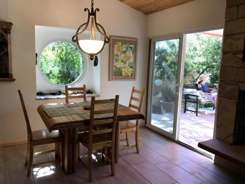 a dining room with a table and chairs and a window at Peaceful Vacation Suite Rental Overlooking Mescal Canyon in Clarkdale, Arizona in Jerome