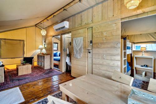 a living room with a wooden wall and a couch at Glorious Tented Cabin with Fire Pit and Gorgeous Sky Views in Sevierville, Tennessee in Wear Valley