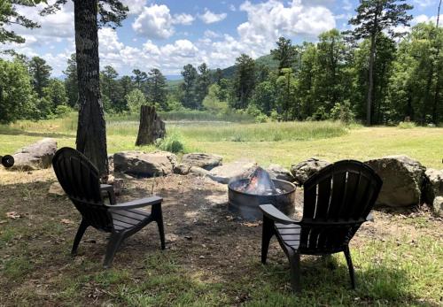 two chairs sitting next to a fire pit at Cozy Cabin Rental near Ozark National Forest for a Relaxing Weekend Getaway in Arkansas in Marble Falls