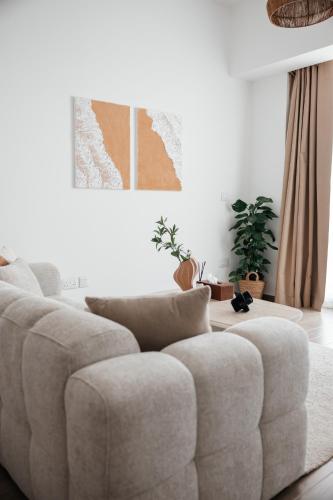 a white couch in a living room with at Desert Home Mayan Yas Island in Abu Dhabi
