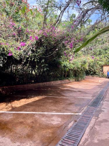 a parking lot with pink flowers and a fence at Eagle View Lodge - Kigali in Kigali