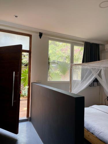 a bedroom with a bed and a large window at Eagle View Lodge - Kigali in Kigali