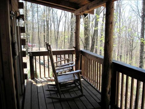 two rocking chairs sitting on a porch of a cabin at Log Cabin in the Clouds with Spectacular Views in Northern Chattanooga, Tennessee in Whitwell