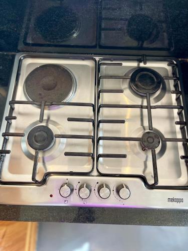 a stove top with four burners on it at Eagle View Lodge - Kigali in Kigali
