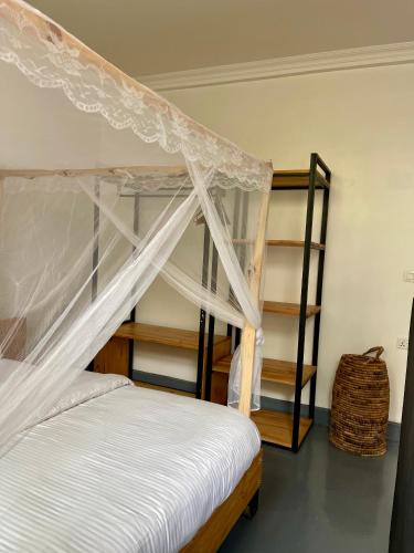 a bedroom with a bunk bed with a canopy at Eagle View Lodge - Kigali in Kigali