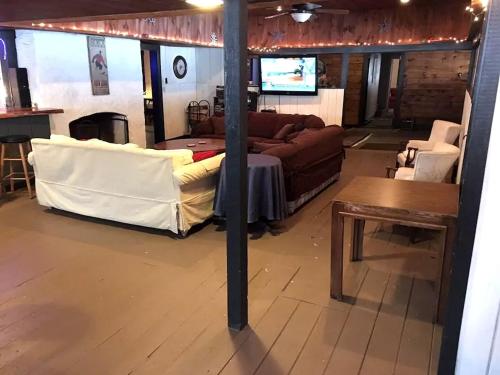 a living room with a couch and a table at Spacious Vacation Rental for Large Groups in the White Mountains near Plymouth, New Hampshire in Plymouth