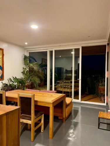 a dining room with a wooden table and chairs at Eagle View Lodge - Kigali in Kigali