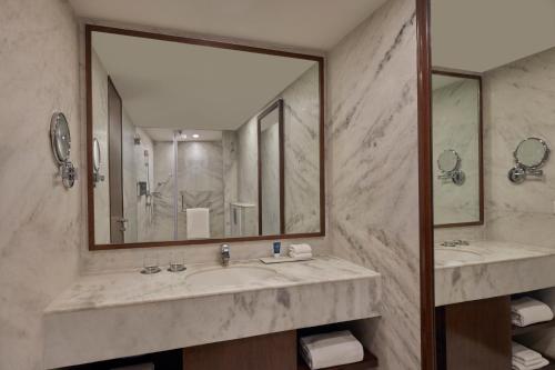 a bathroom with two sinks and a large mirror at Four Points by Sheraton Hotel and Serviced Apartments Pune in Pune