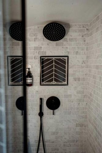 a shower with three windows in a brick wall at Airstream Stay Near Whiskey Row and Granite Creek in Prescott, AZ in Prescott
