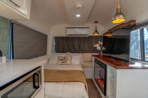 a small room with a bed and a desk at Airstream Stay Near Whiskey Row and Granite Creek in Prescott, AZ in Prescott