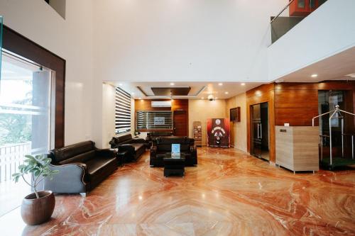 a large living room with a couch and a table at Daksh The Madhuvan Suites Dwarka in Dwarka