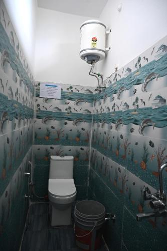 a bathroom with a toilet and a sink at maa kalishila home stay in Ukhimath