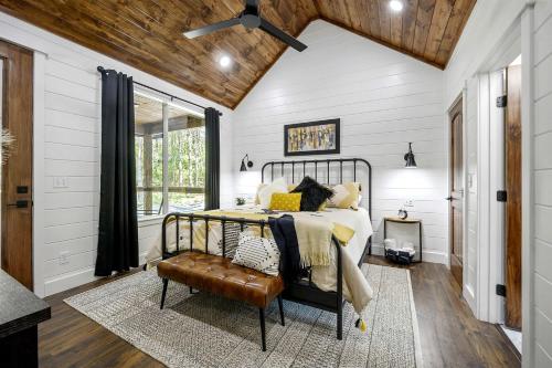 a bedroom with a bed and a wooden ceiling at Breathtaking Luxurious Cabin with Fire Pit, Screened Beautiful Porch and Jacuzzi in Oklahoma in Mount Herman