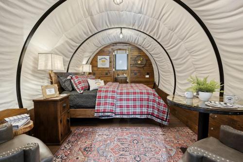 a bedroom with a bed in a tent at Grand Canyon Covered Wagon for Family-Friendly Glamping in Meadview, Arizona in Meadview