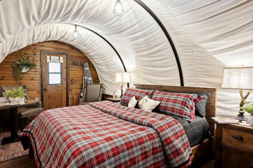 a bedroom with a bed in a tent at Grand Canyon Covered Wagon for Family-Friendly Glamping in Meadview, Arizona in Meadview