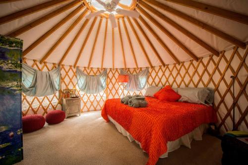 a bedroom with a bed in a yurt at Elegant Yurt Tucked Beneath Oak Trees on Southern California Ranch in Cayucos