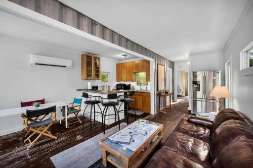 a living room with a couch and a table at Upcycled Shipping Containers Transformed into a Glamping Home for a Unique Florida Vacation in Tequesta