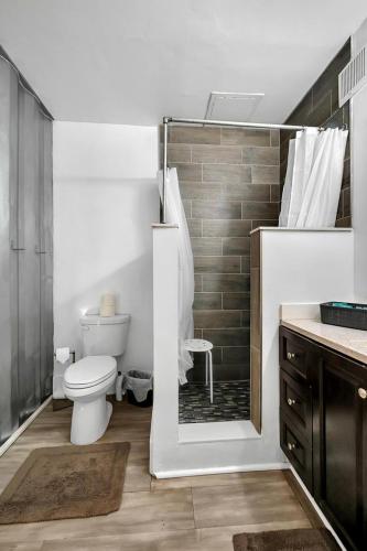 a bathroom with a toilet and a shower and a sink at Upcycled Shipping Containers Transformed into a Glamping Home for a Unique Florida Vacation in Tequesta