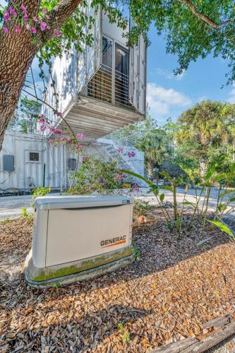 a large appliance sitting on the ground in front of a building at Upcycled Shipping Containers Transformed into a Glamping Home for a Unique Florida Vacation in Tequesta