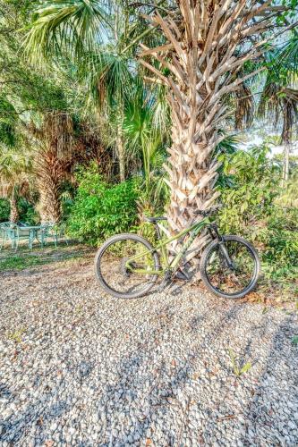 a bike parked next to a palm tree at Upcycled Shipping Containers Transformed into a Glamping Home for a Unique Florida Vacation in Tequesta