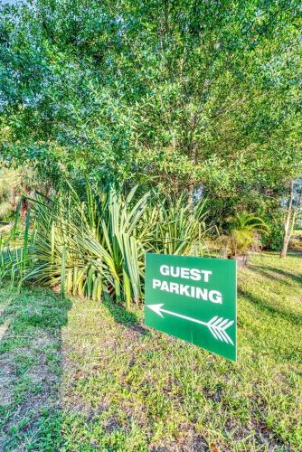 a sign that says guest parking in a park at Upcycled Shipping Containers Transformed into a Glamping Home for a Unique Florida Vacation in Tequesta