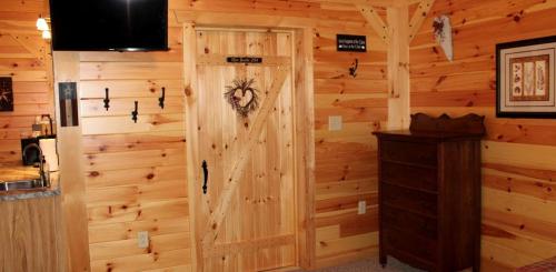a room with a wooden wall with a door at Vacation Rental for Things to Do in Rocky Gap State Park in Flintstone
