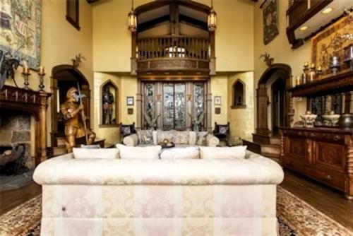 a large living room with a large couch and a fireplace at Regal Suite Rental in Breathtaking Castle near Lake George, Upstate New York in Bolton Landing