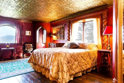 a bedroom with a bed and a large window at Regal Suite Rental in Breathtaking Castle near Lake George, Upstate New York in Bolton Landing
