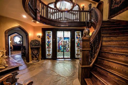 a largeoyer with a wooden spiral staircase and a glass door at Regal Suite Rental in Breathtaking Castle near Lake George, Upstate New York in Bolton Landing