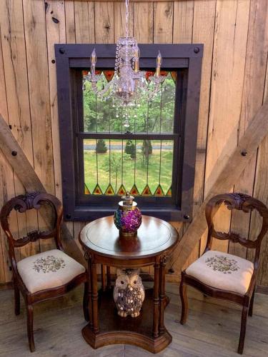 a room with a table and two chairs and a window at Unique Hobbit House Accommodation with a Private Hot Tub in Shenandoah, Virginia in Grove Hill