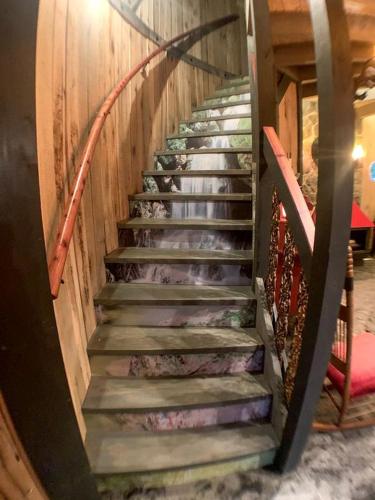 a stairway in a house with a wooden wall at Unique Hobbit House Accommodation with a Private Hot Tub in Shenandoah, Virginia in Grove Hill