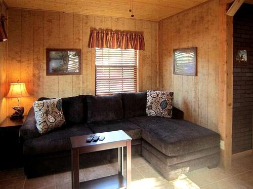 a living room with a couch and a table at Rustic Cabin Perfect for a Romantic Getaway in Inverness, Florida in Inverness