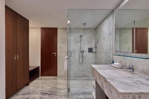 a bathroom with a sink and a shower at Four Points by Sheraton Hotel and Serviced Apartments Pune in Pune