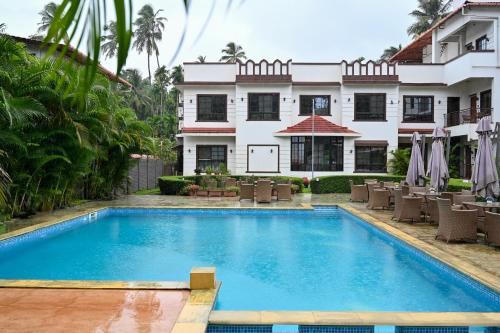 a swimming pool in front of a building at Vaarsa by Bay Hotels in Alibaug