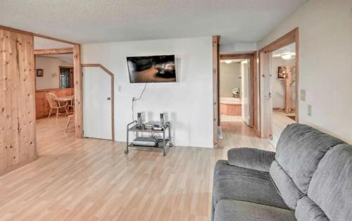 a living room with a couch and a table at Spacious Family Lake Vacation Rental near St David, Maine in Lavertue