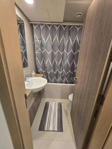 a small bathroom with a sink and a toilet at Luxury 2-Bedroom APT - Sea Views in Saadiyat Island in Abu Dhabi