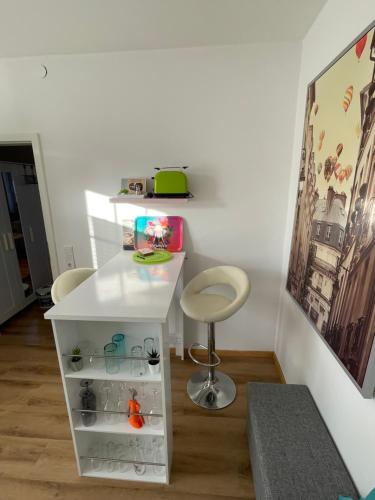 a room with a white desk and a stool at Fewo Happy Heede in Heede
