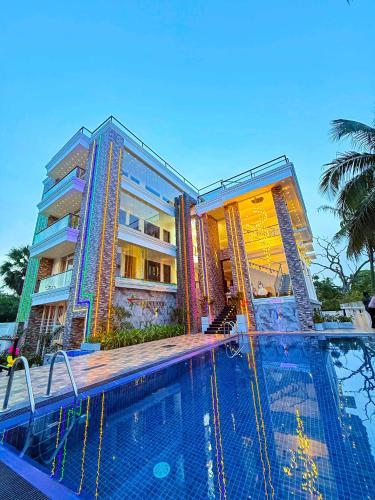 a large swimming pool in front of a building at Radiance Hotel in Trincomalee
