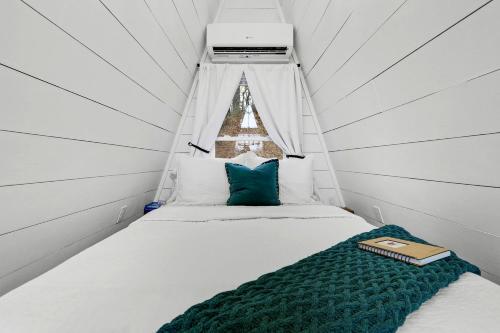 a bed in a small room with a canopy at Intimate Private A-Frame with Spa and Beautiful Outdoor Living in Georgia in Lickskillet