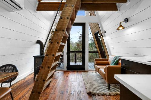 a spiral staircase in a house with a living room at Intimate Private A-Frame with Spa and Beautiful Outdoor Living in Georgia in Lickskillet