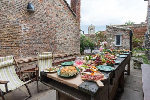 a table with plates of food on a patio at The Haven in Sandwich