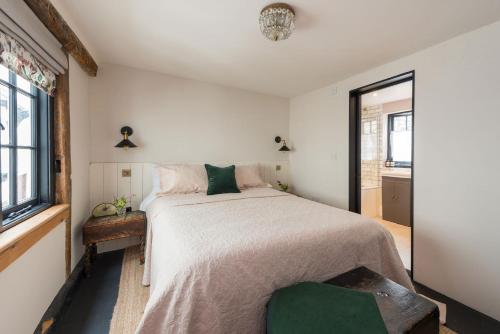 a bedroom with a large bed and a window at The Haven in Sandwich