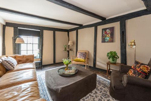 a living room with a couch and a table at The Haven in Sandwich