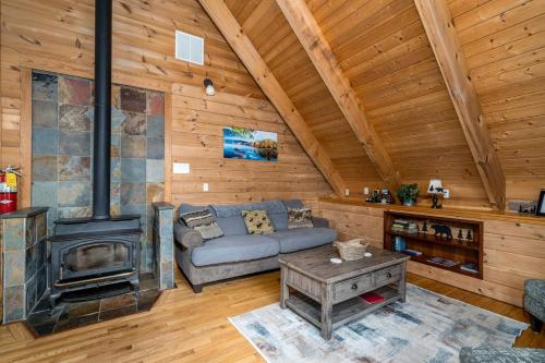 a living room with a couch and a stove at Delightful Cabin Rental with Mountain Views near Chattahoochee National Forest, Georgia in Mineral Bluff