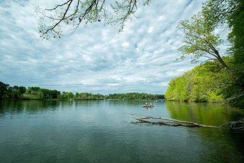 a couple of people in a boat on a river at Impressive Tented Cabin with Peaceful Vistas and Fire Pit in Logan, Ohio in Logan