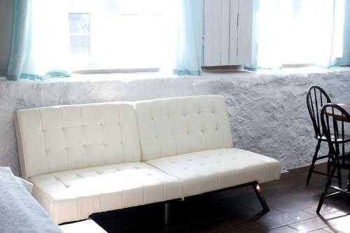 a white couch in a room with a table and chairs at Charming Accommodation for a Weekend Getaway in Buckingham Township, Pennsylvania in Buckingham
